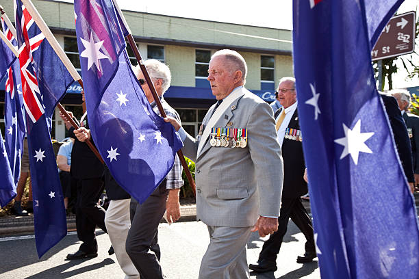 Servicemen marching on Anzac Day with Australian Flags stock photo