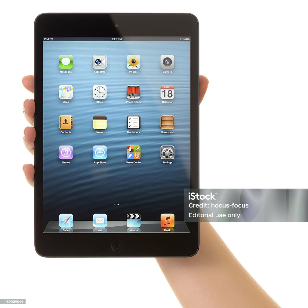 iPad Mini "Astanbul, Turkey - January 18, 2013: Hand holding Apple iPad Mini displaying the homescreen. iPad, the tablet computer with multi touch screen produced by Apple Computer, Inc." Adult Stock Photo