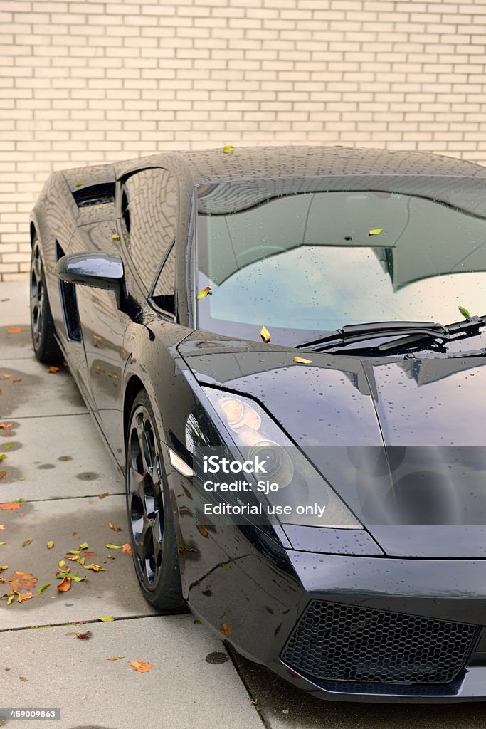 Lamborghini Gallardo Leusden, The Netherlands - October 12, 2012: Black Lamborghini Gallardo sports car parked in front of a brick wall. Black Color Stock Photo