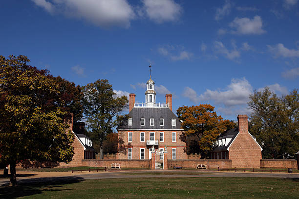 Governor's Palace "Williamsburg, Va. USA - November 5, 2011: On a beautiful sunny day the Governor's Palace sits as the main focus with blue skys and beautiful cloudscape.  The Governor's Palace was home to many Historic Virginian Governor's such as Thomas Jefferson and Patrick Henry.  Building of the Palace started in 1705 and after 16 years of labor in building it was finally completed in 1722." governor's palace williamsburg stock pictures, royalty-free photos & images