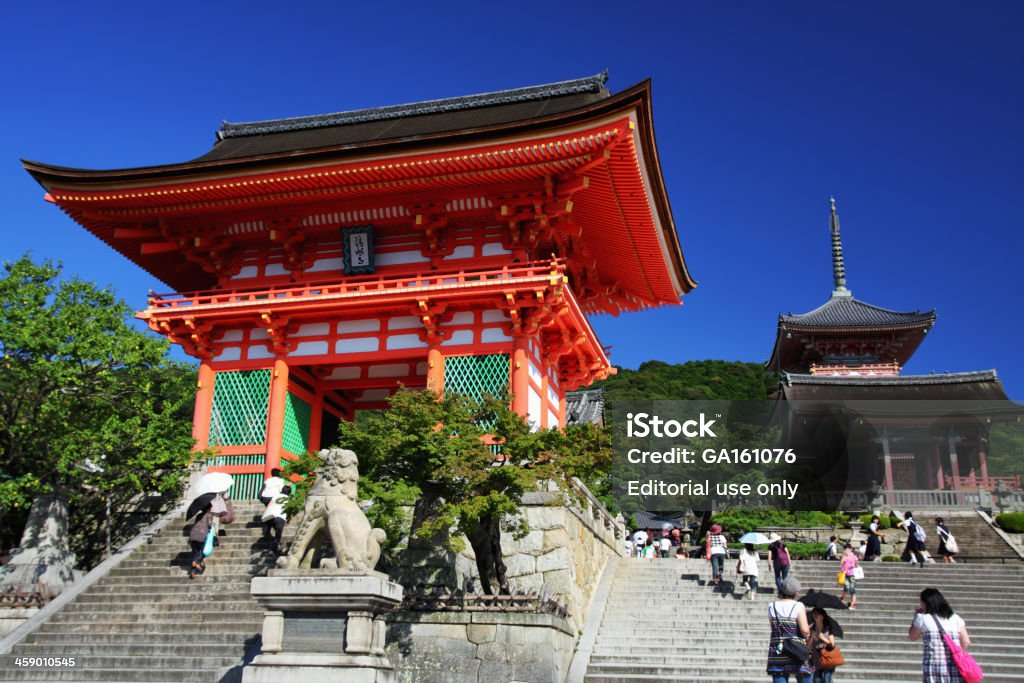 Kiyomizu-dera Temple in Kyoto Kyoto, Japan - September 1, 2009: Japanese people and tourists entering the Deva gate (in the left) and West gate (in the right) of the Otowa-san Kiyomizu-dera Temple in Kyoto. The temple dates back to 798, but the present buildings were constructed in 1633. The temple takes its name from the waterfall within the complex, which runs off the nearby hills. Kiyomizu literally means pure water, clear water or limpid water. UNESCO world heritage site. Ancient Stock Photo