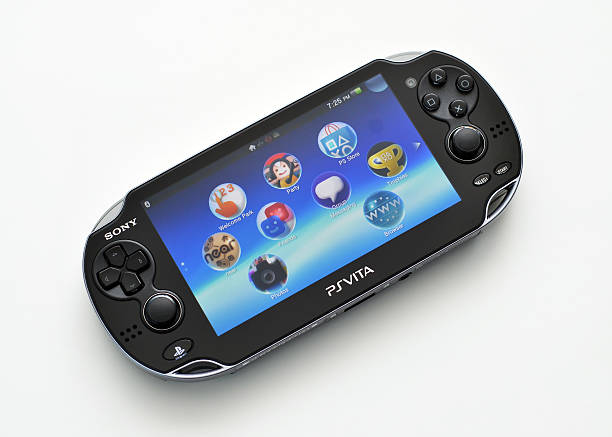 Playstation Vita "Vancouver, Canada -- April 3, 2012:Close up of a Playstation Vita handheld game system on a white background.  PS Vita is from Sony Computer Entertainment and is available worldwide." handheld video game stock pictures, royalty-free photos & images