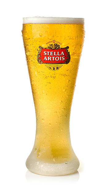 Stella Artois "St Ives, England - January 1, 2013:: A glass of ice cold Stella Artois, a 5A ABV lager originating from Leuven, Belgium." pint of stella stock pictures, royalty-free photos & images