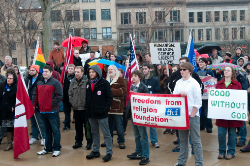 Madison, Wis. USA- March 9, 2013: Attendees from the University Wisconsin-Madison's Freethought Festival hold a rally for atheism and the separation of church and state outside the Wisconsin State Capitol.
