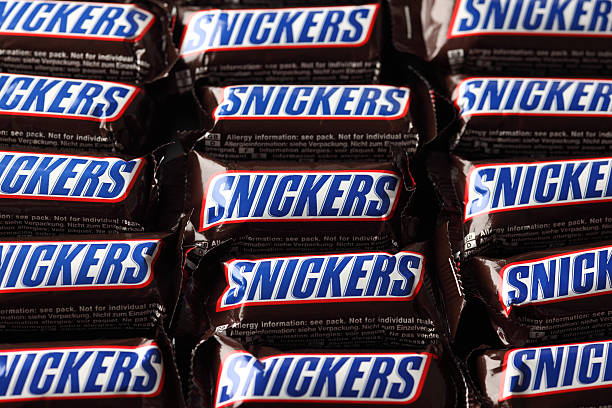 Snickers candy bars "Tambov, Russian Federation - September 01, 2012: Snickers minis candy bars heap. Full Frame. Studio shot. Snickers bar is a chocolate bar with caramel and peanuts, manufactured by Mars, Incorporated." Snickers stock pictures, royalty-free photos & images
