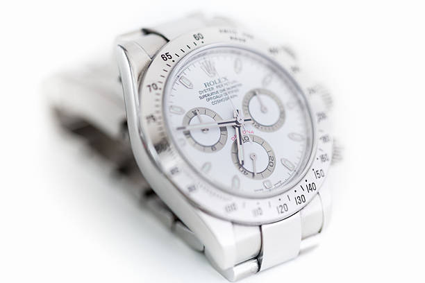 Rolex Daytona Cosmograph "Stuttgart, Germany - February 6, 2013: Rolex Cosmograph Daytona Oyster Perpetual Referencenr.: 116520 luxury wristwatch with white dial, steel case and steel bracelet in front of white background. Selective Focus, Very Small DOF." swiss watches stock pictures, royalty-free photos & images