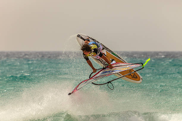 Fuerteventura, Spain - August 2, 2010: Young windsurfer doing his jumps at the Windsurfing and Kiteboarding World Cup, taking place every year between July and August.