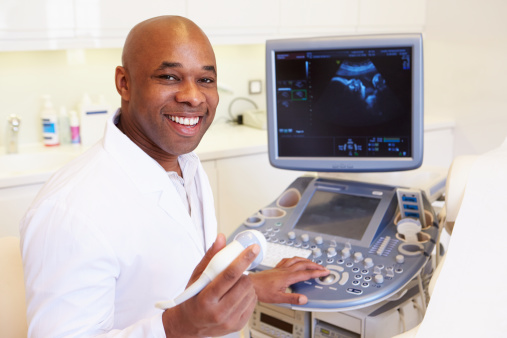 Portrait Of 4D Ultrasound Scanning Machine Operator Smiling At Camera