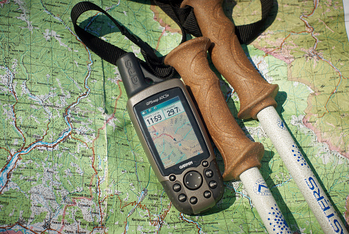 Carpathians, Ukraine - August 04, 2009: GPS device and  trekking poles on a map of carpathians mountains.
