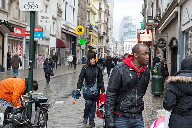 Brussels, Belgium - January 31, 2013: People walk through a pedestrian area near Grand Place in downtown Brussels on a rainy winter day.
