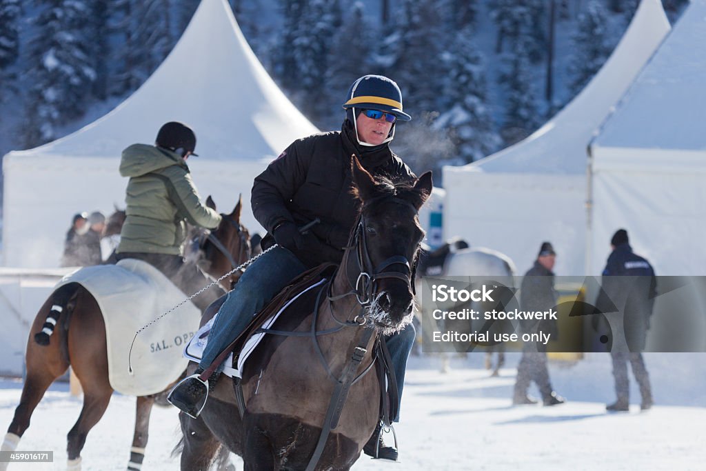 Snow Polo Warm Up St. Moritz, Switzerland - January 27, 2013: A rider warms up a polo pony on a frosty winter morning prior to the first game at the St. Moritz Polo World Cup on Snow. The St. Moritz Polo World Cup on Snow is the worlds most prestigious winter polo tournament. Four high-goal teams with handicaps between 15 and 18 goals battle for the coveted Trophy on the frozen surface of Lake St. Moritz. 2013 Stock Photo