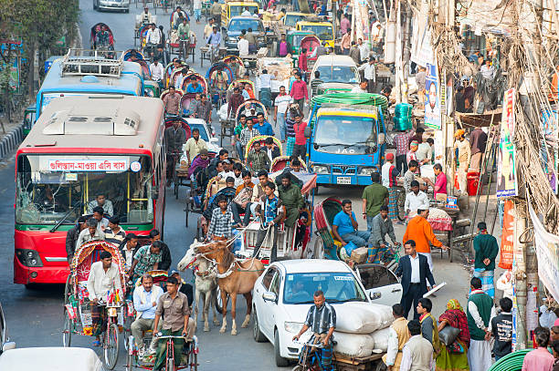 Busy traffic in Dhaka street, Bangladesh "Dhaka, Bangladesh - January 26, 2013: People fighting their way in a busy street in old Dhaka, Bangladesh." bangladesh photos stock pictures, royalty-free photos & images