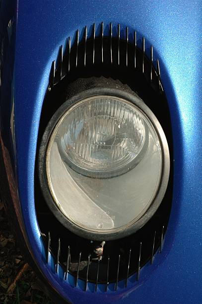 Lamborghini Miura Apeldoorn, The Netherlands - September 4, 2005: Lamborghini Miura headlight on a blue Lamborghini Miura supercar. The Miura is a mid-engined V12 coupe produced in the 1960s. lamborghini miura stock pictures, royalty-free photos & images