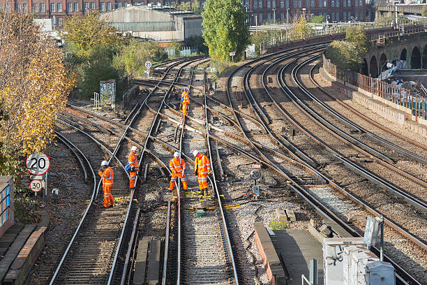Rail track maintenance "London, UK - November 5, 2012: A team of rail track maintenance workers inspecting and repairing a railway track during the day in London." wandsworth photos stock pictures, royalty-free photos & images
