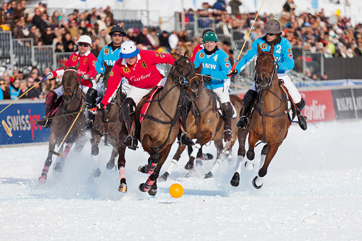 St. Moritz, Switzerland - January 27, 2013: Team Cartier's player #4 was able to break from the pack and is about to take a shot at the goal at the St. Moritz Polo World Cup on Snow. The St. Moritz Polo World Cup on Snow is the worlds most prestigious winter polo tournament. Four high-goal teams with handicaps between 15 and 18 goals battle for the coveted Trophy on the frozen surface of Lake St. Moritz.