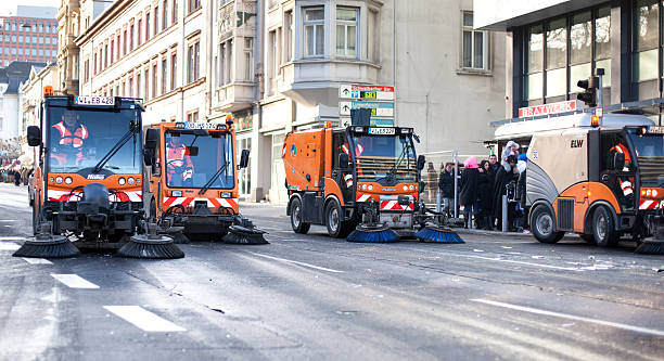 Street sweepers "Wiesbaden, Germany - February 10, 2013: Convoi of street sweeper trucks at work after a carnival parade in the city center of Wiesbaden, Germany. Minor motion blur, selective focus" street sweeper stock pictures, royalty-free photos & images