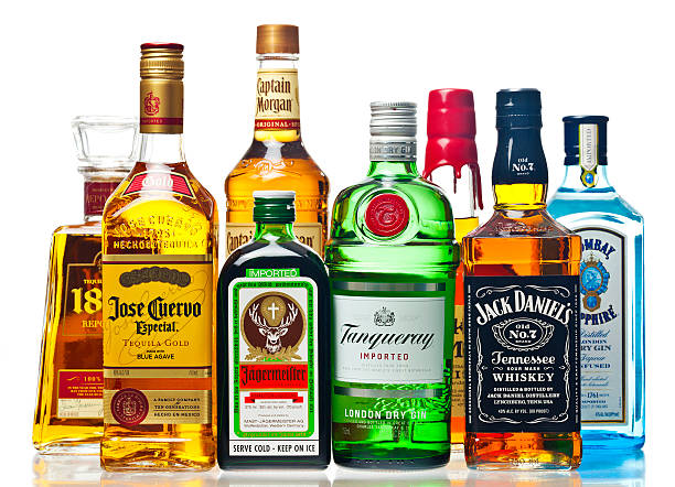 Liquor Bottles On A White Background "Richmond, Virginia, USA - March 11th, 2013:  Liquor Bottles On A White Background.  The Liquors Are 1800, Jose Cuervo, Jagermeister, Captain Morgan, Tanqueray, Maker's Mark, Jack Daniels, And Bombay Sapphire." saloon photos stock pictures, royalty-free photos & images
