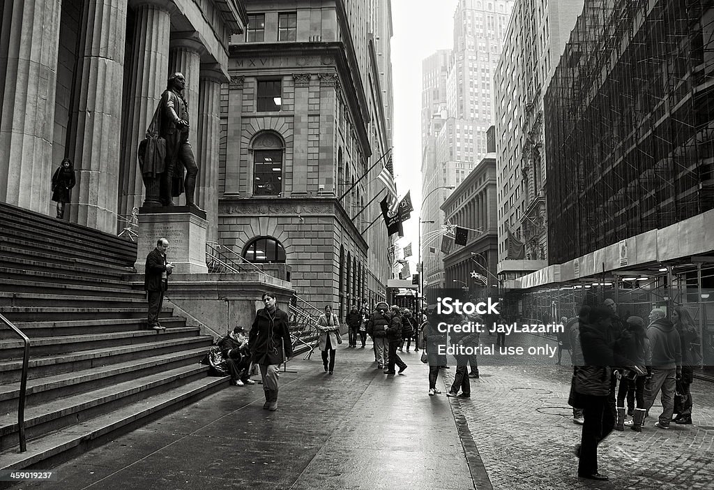 Tourists along Wall Street at Federal Hall, Lower Manhattan, NYC "New York City, USA - December 10, 2012: Groups of tourists gathered in front of Federal Hall on a foggy day along Wall and Financial District of Lower Manhattan." George Washington Stock Photo