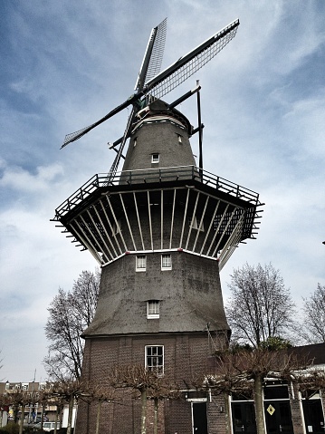 Amsterdam, The Netherlands - March 22, 2013: An 18th century grain mill survives in the eastern docklands area of Amsterdam. 