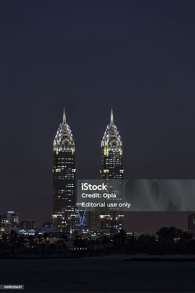 Al Kazim towers, Dubai. "Dubai, United Arab Emirates - January 17, 2013: Al Kazim towers, Dubai. Taken from the Palm Jumeirah. A complex of two 53-floor towers in Dubai Media City. The towers are 265m high and resemble the New york City's Chrysler Building." Apartment Stock Photo