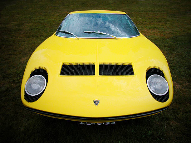 Lamborghini Miura S Apeldoorn, The Netherlands - August 31, 2003: Front view on a yellow Lamborghini Miura parked in a field. The Lamborghini Miura was a sports car produced by Italian automaker Lamborghini between 1966 and 1972 and is considered to be the first real supercar. lamborghini miura stock pictures, royalty-free photos & images