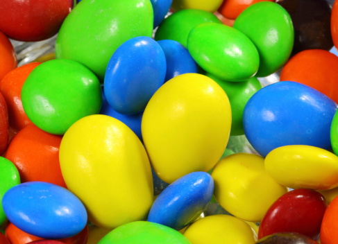 Macro shot of a bowl with many sweet colorful candies
