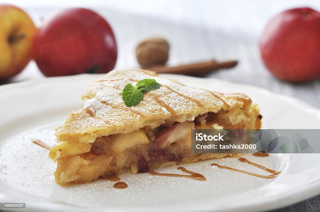 Slice of homemade apple pie Slice of homemade apple pie with fresh apples on wooden background Apple - Fruit Stock Photo