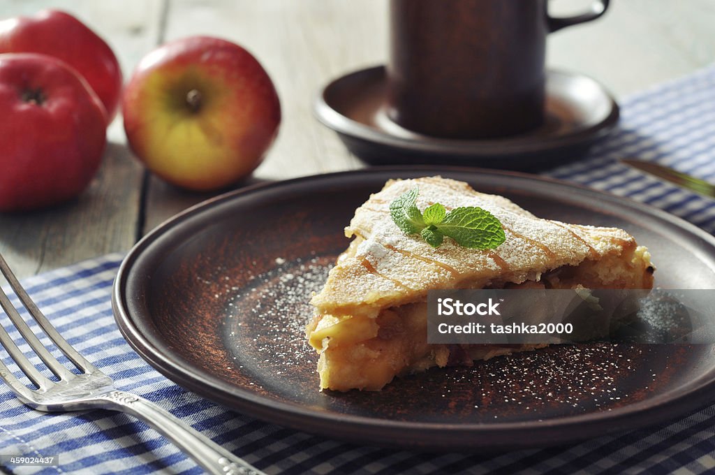 Slice of homemade apple pie Slice of homemade apple pie with fresh apples on wooden background Apple - Fruit Stock Photo