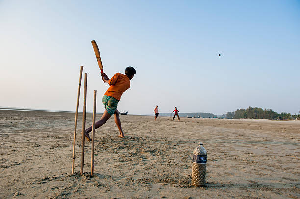 junger mann spielen cricket am strand, bangladesch - benglalese stock-fotos und bilder