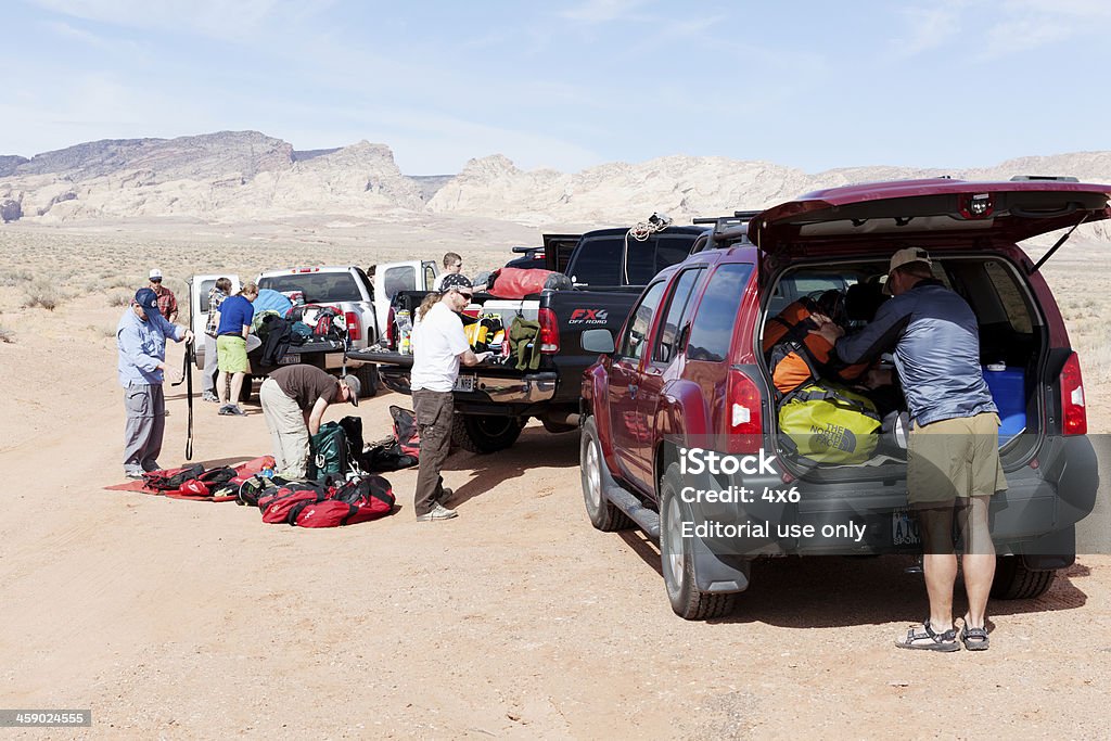 Getting ready to go canyoneering Hanksville, Utah, USA - March 30, 2012. A group of people are getting their gear ready to go canyoneering. This is where they will leave their vehicle before hiking into the canyons. 2012 Stock Photo