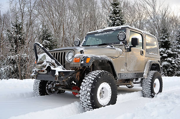 Jeep stradling a deep crevice in a mountain road. Processed RAW.
