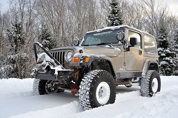 Jeep Off-Roading in the Snow "Springhill, Nova Scotia, Canada - February 12, 2012: A Jeep Wrangler 4x4 goes off-roading in the snow." creighton stock pictures, royalty-free photos & images