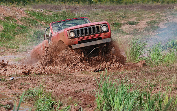 Mud-bogging "Annapolis Valley, Nova Scotia, Canada - August 27, 2011: An International Scout 4x4 blasts through a mud bog." creighton stock pictures, royalty-free photos & images