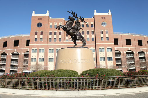 Tallahassee, Florida, USA - March 3, 2013: The Unconquered Student Statue at Doak Campbell Stadium that celebrates the human spirit that will not be defeated