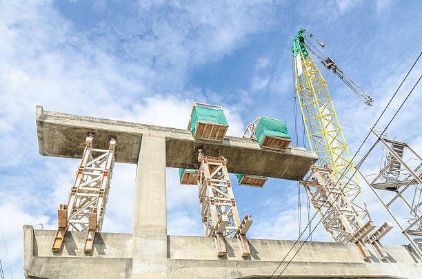 istock Industrial construction crane are operating over blue sky 459026637