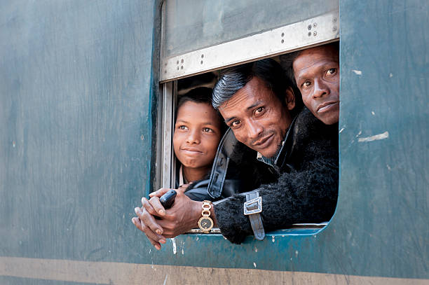 Passengers at the window of coach, Bangladesh "Sylhet, Bangladesh - February 16, 2013: Two passengers are looking outside the window of coach in the small railway station of Srimangal, which is the most important tea producing place in Bangladesh." sylhet stock pictures, royalty-free photos & images