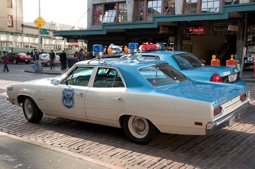 Seattle, USA - March 4, 2013: Original 1970s Plymouth Satellite Police car on the corner of Pike and 1st ave just before sunset.