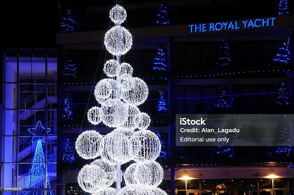 The Royal Yacht hotel, Jersey. "Jersey, U.K. - December 5, 2012: Festively lit modern LED outside lights illuminating The Royal Yacht hotel and nightclub at night." Architecture Stock Photo