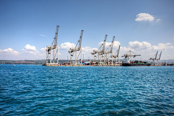 Cranes and boats at Koper docks in Slovenia "Koper, Slovenia - July 4, 2012: Cranes and boats at Koper docks in Slovenia. The boat is moored at the jetty for loading and unloading of cargo" koper slovenia stock pictures, royalty-free photos & images