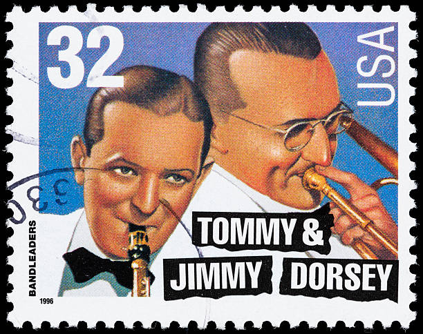 USA Tommy &amp; Jimmy Dorsey postage stamp "Sacramento, California, USA - September 21, 2012: A 1996 USA postage stamp with an illustration of brothers and big band bandleaders Tommy Dorsey (1905-1956) and Jimmy Dorsey (1904-1957)." big band jazz stock pictures, royalty-free photos & images