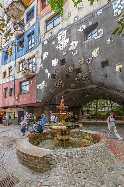 Hundertwasser House, Vienna Vienna, Austria- September 8, 2012: Tourists in front of the Hundertwasser House, that with its colorfully decorated facade, is one of the Vienna major attractions. It was built between 1983 and 1985 and became immediately one of the city art landmarks. hundertwasser haus in vienna austria stock pictures, royalty-free photos & images