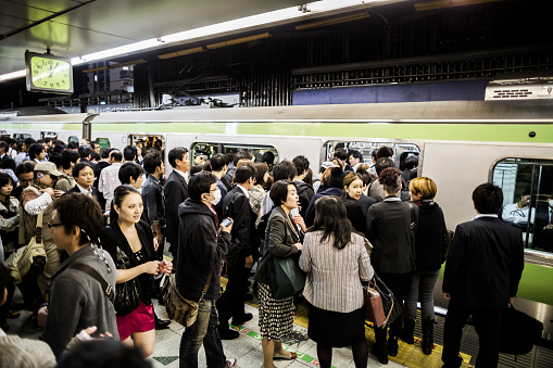 Tokyo, Japan - October 27, 2012: Crowd waiting for a subway train of the Yamanote Line in Tokyo Japan. Accounting the subway lines and all the other railways that operate in Tokyo 40 million people travel with this kind of transportation everyday in the city.