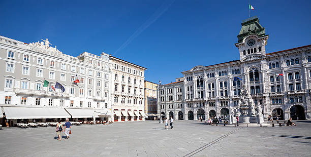 Palazzo Comunale and Casa Stratti - Trieste, Italy "Trieste, Italy - September 7, 2012: Facades of the town hall Palazzo Comunale and Casa Stratti in the city center of Trieste. Some pedestrians and tourists in front of the buildings. Trieste is an italian city and seaport in northeastern Italy close to the border with Slovenia" trieste stock pictures, royalty-free photos & images