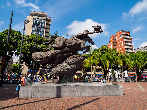 Plaza de Bol&#237;var,Pereira, Colombia "Pereira, Colombia - June 19, 2009: Plaza de Bolivar in the Colombian town of Pereira where people sit next to the Naked Bolivar sculpture by Rodrigo Arenas Betancur which is a prominent feature of the town square. Many others can be seen in the background." 2009 stock pictures, royalty-free photos & images