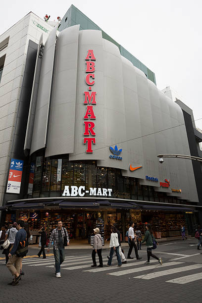 ABC-Mart GrandStage Ikebukuro in Japan "Tokyo, Japan - September 28, 2012: Pedestrians walk past the ABC-Mart GrandStage Ikebukuro in Tokyo, Japan. ABC-Mart is a Japan-based company mainly engaged in the sale of shoes." reebok stock pictures, royalty-free photos & images