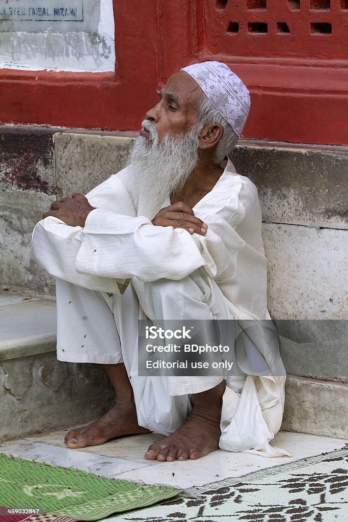 Celebrating Ramadan, New Delhi, India "New Delhi, India - August 12, 2012. An Indian Muslim man relaxing during Ramadan at the shrine of 13th century Sufi Muslim saint Hazrat Nizamuddin Aulia." Adult Stock Photo