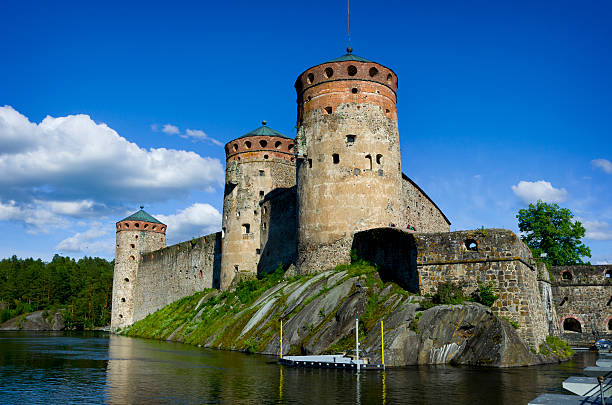 Olavinlinna Castle Finland "Savonlinna, Finland - June 26, 2012: Medieval castle called Olavinlinna located in the city of Savonlinna, Finland. The castle is the venue of the annual Savonlinna Opera Festival. See http://en.wikipedia.org/wiki/Olavinlinna. The castle recflects off the still surface of Lake Saimaa on a sunny summer day." etela savo finland stock pictures, royalty-free photos & images