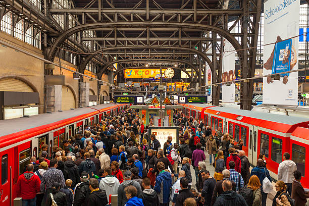 Hamburg S-Bahn station "Hamburg, Germany - September 17, 2011: Crowded station platform of the Hamburg S-Bahn at the Hamburg hauptbahnhof. Many people can be seen on the platform, some of which can be seen wearing scarves and blue jerseys to support a local football team." subway platform stock pictures, royalty-free photos & images
