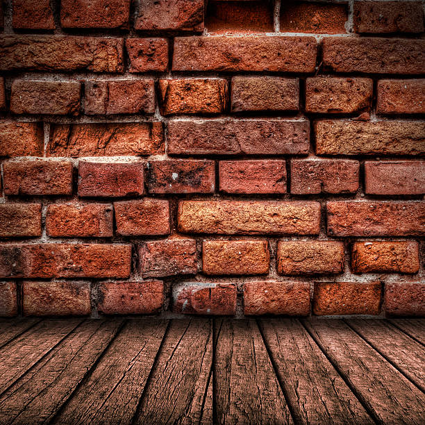 Red brick wall and wooden floor interior stock photo