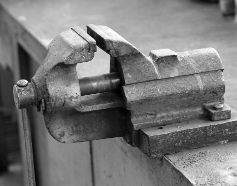 strong work in a vise Workbench of a blacksmith in a mechanical workshop